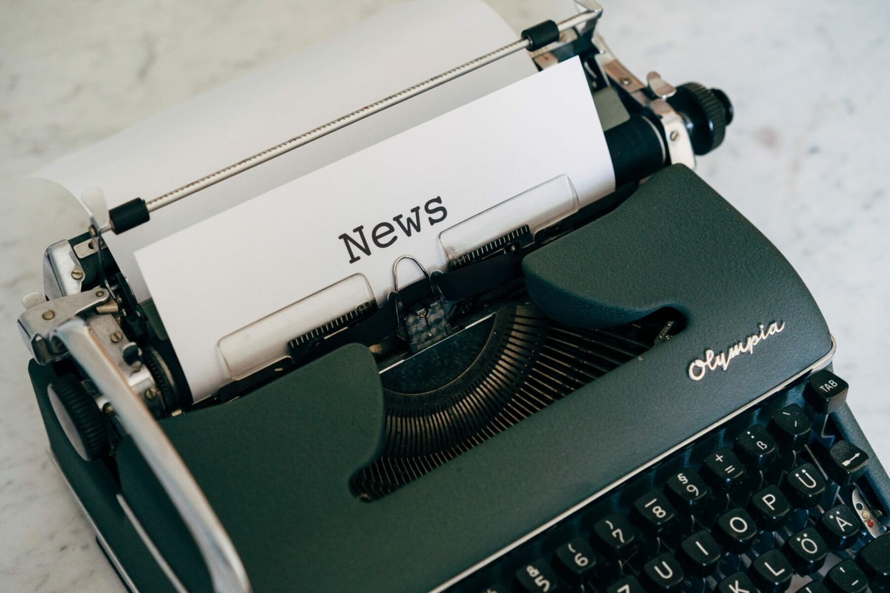 A typewriter with the word 'News' typed on a page